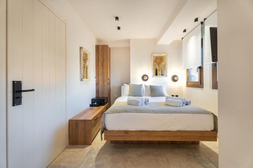 a bedroom with a king sized bed in a room at Mpikas Holidays in Ierissos