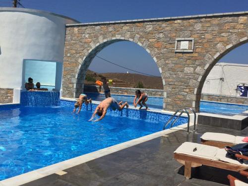 a group of people playing in a swimming pool at Vigla Hotel in Aegiali