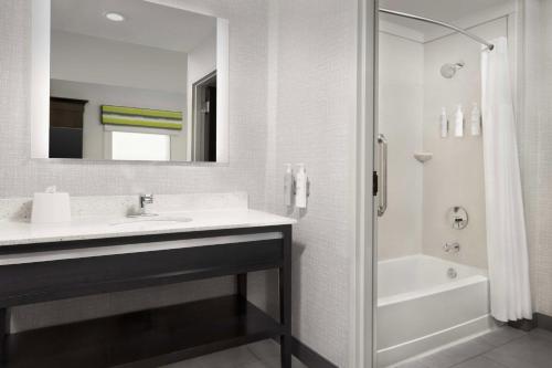 a white bathroom with a sink and a shower at Hampton Inn & Suites El Paso/East in El Paso