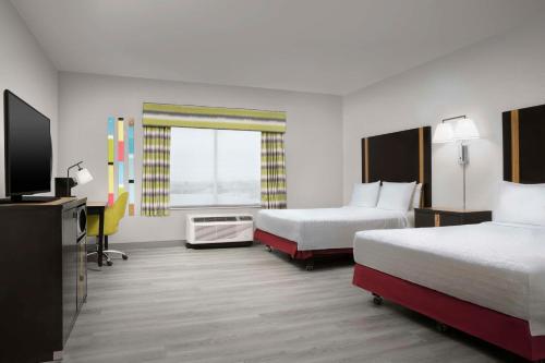 a hotel room with two beds and a television at Hampton Inn & Suites El Paso/East in El Paso