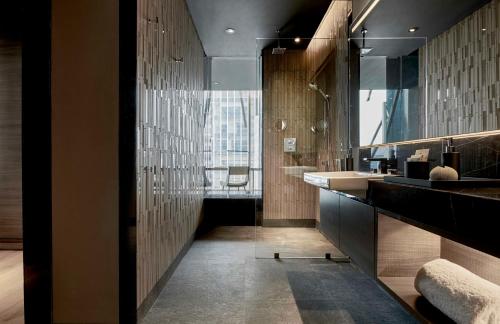 a bathroom with a sink and a large mirror at Alila SCBD Jakarta in Jakarta