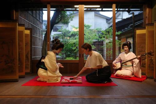a group of women sitting on the floor in a room at Hyatt Centric Kanazawa in Kanazawa