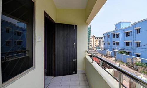 a door on the side of a building with a balcony at Goroomgo Bollywood Sea View Room Puri in Puri