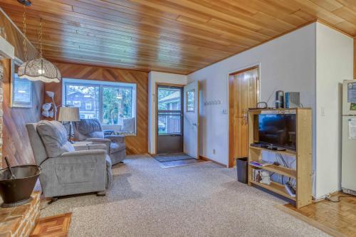 a living room with a couch and a tv at Cabin on the Coast MCA 621 - Meredith Lodging in Manzanita