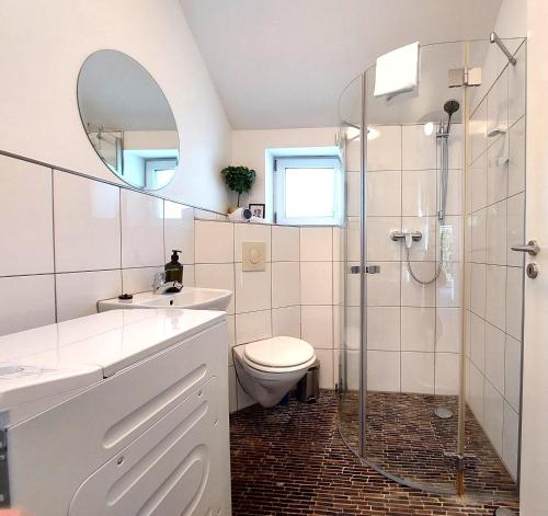 a bathroom with a toilet and a glass shower at Airport-Messe Apartments in Düsseldorf