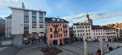 a group of buildings on a city street at Grand Appartement Les Lumières d'Evian in Évian-les-Bains