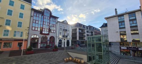 a city street with buildings and a glass case at Grand Appartement Les Lumières d'Evian in Évian-les-Bains