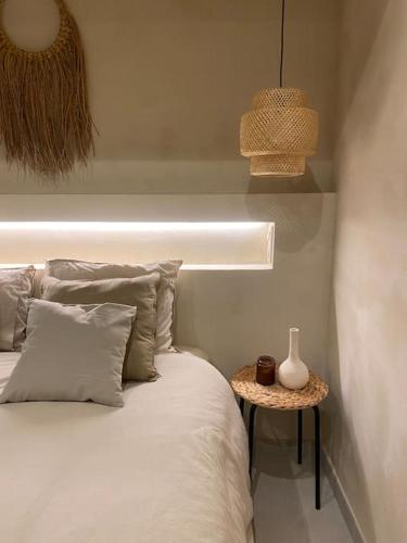 a bedroom with a white bed and a table at Emuna House A Coruña in A Coruña