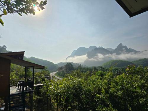 a room with a view of a valley with mountains at Khao Sok Horizon in Ban Bang Thong