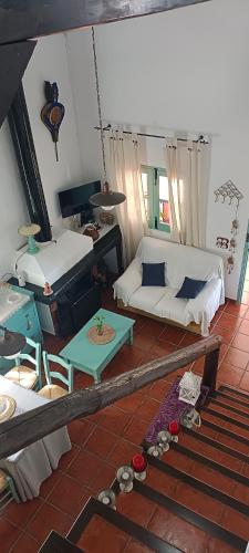 a living room with a couch and a table at Las Hazuelas Villa 15 in Algámitas