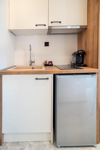 a kitchen with a sink and a dishwasher at Mpikas Holidays in Ierissos