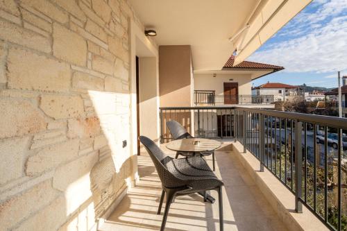 a patio with two chairs and a table on a balcony at Mpikas Holidays in Ierissos
