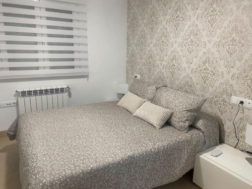 a bedroom with a bed and a window at Villa Jacaranda in Torre-Pacheco