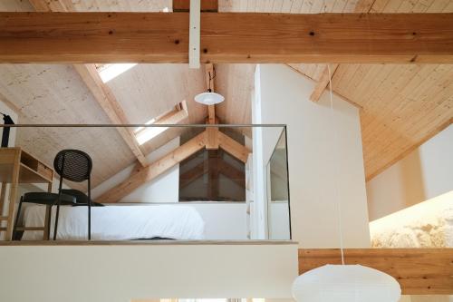 a room with a bed and a chair at Corujeira Apartments by MyALPlace in Porto