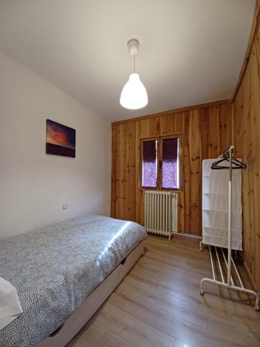 a bedroom with a bed in a room with wooden walls at VUT Casa de la Catedral Alta in Sigüenza