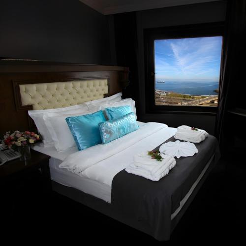 a bedroom with a bed with towels on it at Funda Hotel in Trabzon