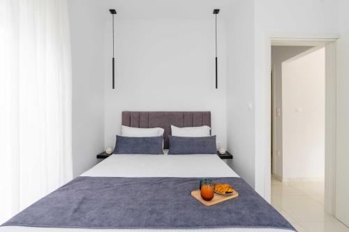a bedroom with a bed with a tray of oranges on it at Arcade Apartments in Volos