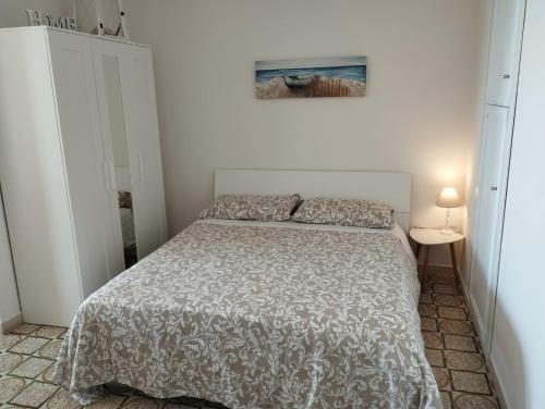 a bedroom with a bed and a picture on the wall at LA TERRAZZA SUL TIRRENO in Nettuno