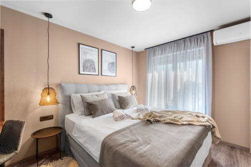 a bedroom with a large bed and a window at Quercus Village Penthouse with jacuzzi in Novigrad Istria