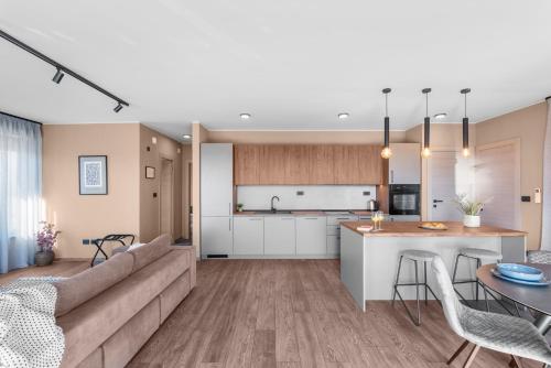 a kitchen and living room with a couch and a table at Quercus Village Penthouse with jacuzzi in Novigrad Istria