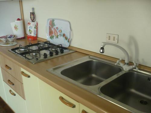 a kitchen with a sink and a stove at Appartamento Michela in Brenzone sul Garda