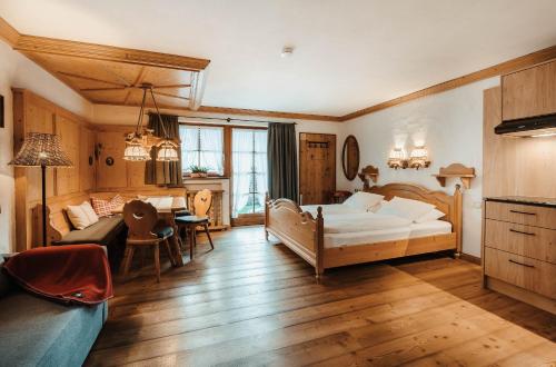 a bedroom with a bed and a living room at Fiakerhof in Garmisch-Partenkirchen