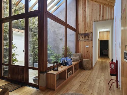 a room with large windows and a living room with a couch at Casa do Cinzeiro in Nordeste