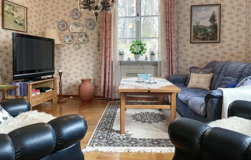 a living room with a couch and a table at 2 Bedroom Awesome Home In Storfors in Storfors