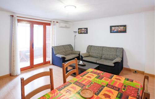 a living room with a table and a couch at Cozy Apartment In Torrevieja With Wifi in Torrevieja