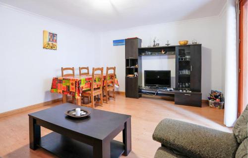 a living room with a couch and a table and chairs at Cozy Apartment In Torrevieja With Wifi in Torrevieja