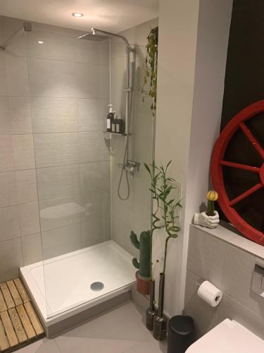a bathroom with a shower with a glass door at The Hoxton Nest - Shoreditch in London