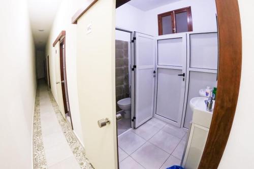 a bathroom with a shower and a sink and a toilet at MARHABA INN by HB Hostels in Tetouan