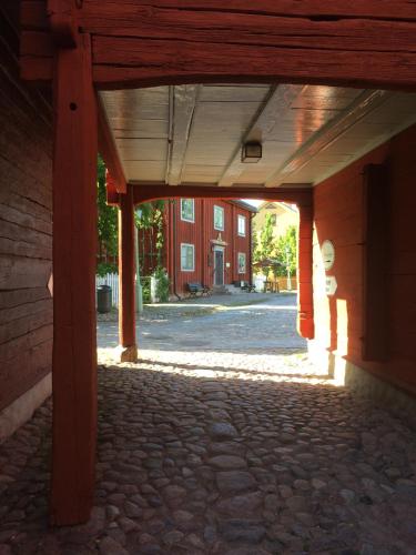 an empty hallway of a building with a brick floor at Linköpings Cityhotell och Vandrarhem in Linköping