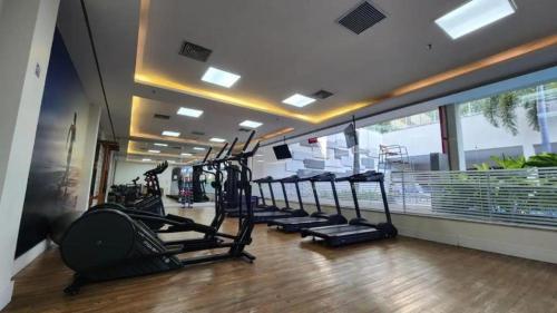 a gym with a row of treadmills at Neolink Barra da Tijuca in Rio de Janeiro