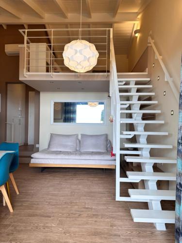 a bedroom with a loft bed and a staircase at Summer Sea Verde Blu Apt in Corfu Town