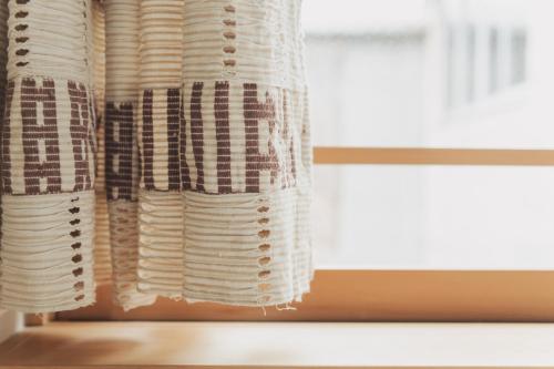 a stack of white plates on a window sill at Une stay&diner in Sasayama