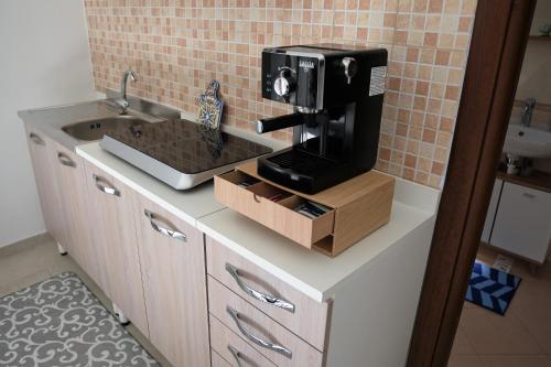a kitchen with a coffee maker on a counter at CasApulia - Bari Airport apartment in Bitonto