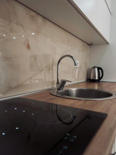 a kitchen counter with a sink and a counter top at M&N Residence Tivat in Tivat