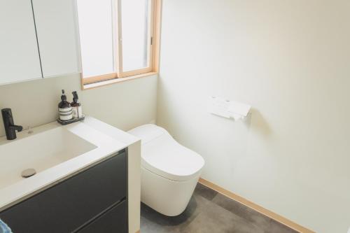 a bathroom with a toilet and a sink at Une stay&diner in Sasayama