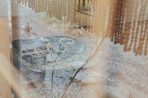 a close up of a glass window with a table at Une stay&diner in Sasayama