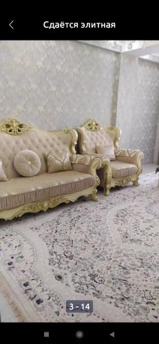 two white couches are sitting in a room at 1 комнатная квартира in Bishkek