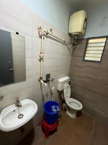 a bathroom with a sink and a toilet and a mirror at THE ALP HOTEL in Madurai