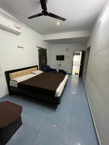 a bedroom with a bed and a ceiling fan at THE ALP HOTEL in Madurai