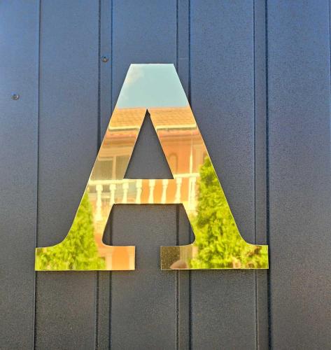 a letter cut out of a door with a house at Villa Magnat in Berehove
