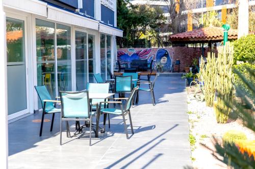 a patio with chairs and tables in front of a building at Mene City Hotel in Antalya