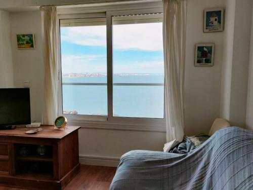 a bedroom with a bed and a large window at Faro Cabo de Palos in Cabo de Palos