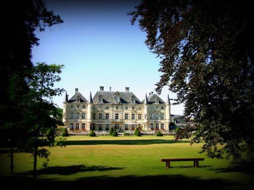 a large house with a bench in front of it at Château des Monthairons Hôtel Restaurant GastroMaison Spa privatif in Les Monthairons