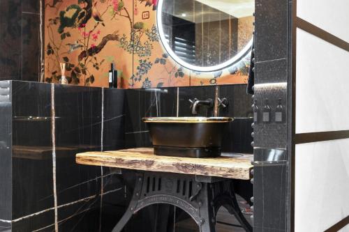 a bathroom with a sink and a mirror at Normanton Park House - Luxury Rutland Water Home in Oakham