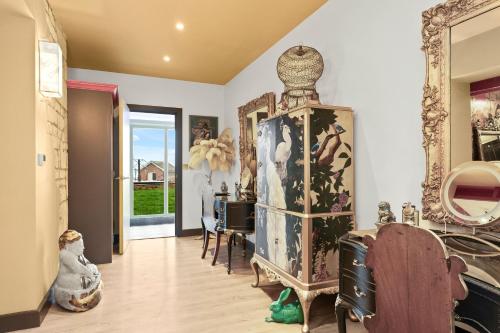 a living room filled with lots of furniture at Normanton Park House - Luxury Rutland Water Home in Oakham