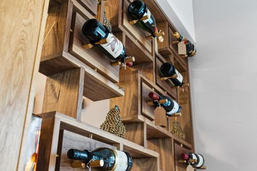 a wall of wine bottles in a wine cellar at Normanton Park House - Luxury Rutland Water Home in Oakham